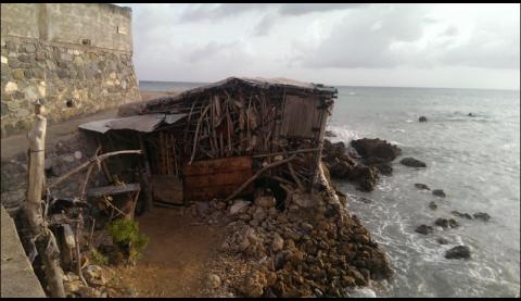 fishing shack falling into ocean in Jamaica