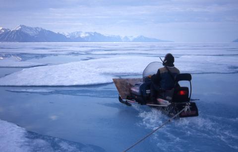 Inuit hunter traveling on melting sea ice