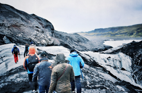 People hiking across a glacier