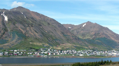 Siglufjörður town tucked beneath a giant bare mountain